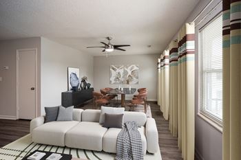 A living room with a white couch and a television.